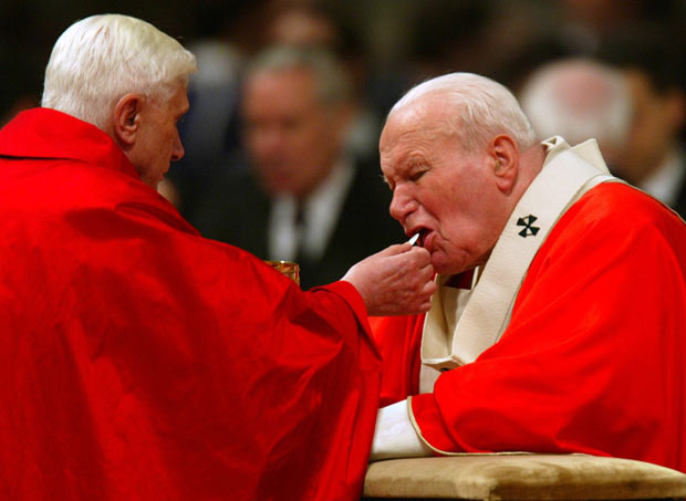 Joseph Cardinal Ratzinger giving Pope John Paul II Holy Communion.